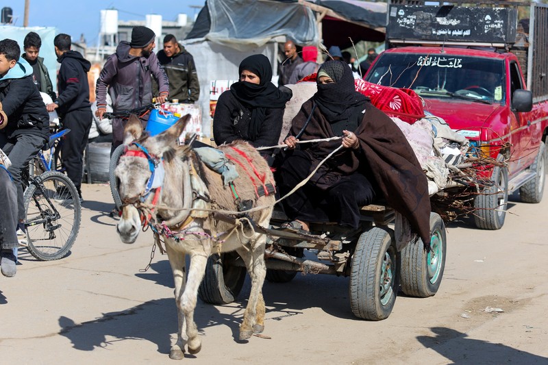 Warga Palestina yang melarikan diri dari Khan Younis, akibat operasi darat Israel, di tengah konflik yang sedang berlangsung antara Israel dan kelompok Islam Palestina Hamas, bergerak menuju Rafah, di selatan Jalur Gaza, 25 Januari 2024. (REUTERS/Ibraheem Abu Mustafa)