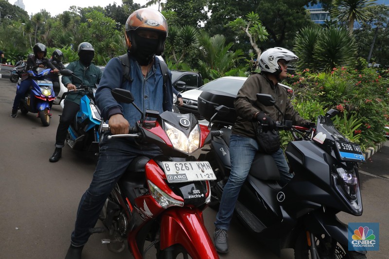 Sejumlah pengendara sepeda motor listrik mengikuti riding bareng motoe RI-1 di depan Gedung PLN, Jakarta, Minggu (28/1/2024). (CNBC Indonesia/Muhammad Sabki)