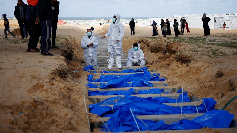 Warga Palestina menguburkan jenazah orang yang tewas dalam pertempuran dengan Israel dan dikembalikan ke Gaza oleh militer Israel, saat pemakaman massal di Rafah, Jalur Gaza, Selasa, 30 Januari 2024. (AP Photo/Fatima Shbair)