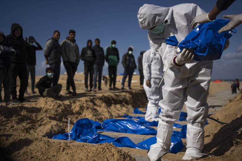 Warga Palestina menguburkan jenazah orang yang tewas dalam pertempuran dengan Israel dan dikembalikan ke Gaza oleh militer Israel, saat pemakaman massal di Rafah, Jalur Gaza, Selasa, 30 Januari 2024. (AP Photo/Fatima Shbair)