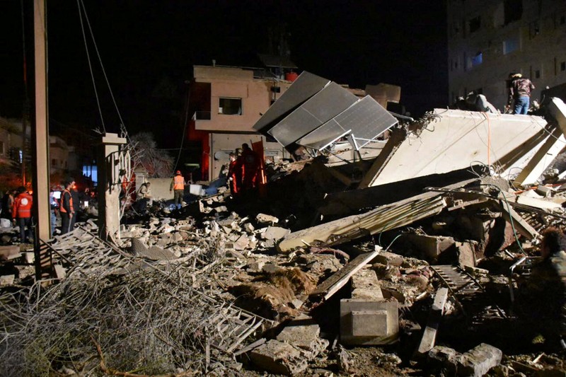 SYRIA-SECURITY/ISRAEL Rescuers search for survivors under the rubble of a damaged building, after Israeli missiles struck a number of sites in Syria's Homs province, according to state media, Syria February 7, 2024. SANA/Handout via REUTERS ATTENTION EDITORS - THIS IMAGE WAS PROVIDED BY A THIRD PARTY. REUTERS IS UNABLE TO INDEPENDENTLY VERIFY THIS IMAGE.