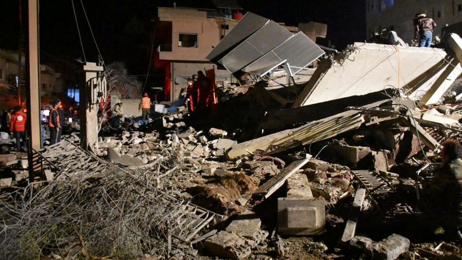 Rescuers search for survivors under the rubble of a damaged building, after Israeli missiles struck a number of sites in Syria's Homs province, according to state media, Syria February 7, 2024. SANA/Handout via REUTERS     ATTENTION EDITORS - THIS IMAGE WAS PROVIDED BY A THIRD PARTY. REUTERS IS UNABLE TO INDEPENDENTLY VERIFY THIS IMAGE.