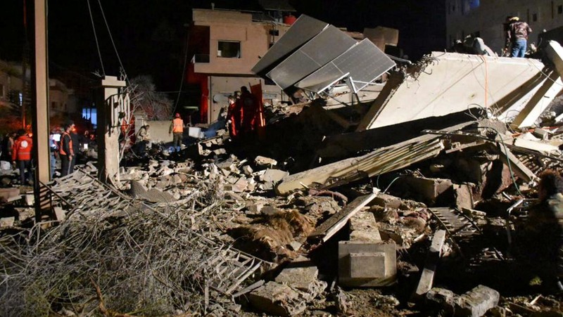 Rescuers search for survivors under the rubble of a damaged building, after Israeli missiles struck a number of sites in Syria's Homs province, according to state media, Syria February 7, 2024. SANA/Handout via REUTERS     ATTENTION EDITORS - THIS IMAGE WAS PROVIDED BY A THIRD PARTY. REUTERS IS UNABLE TO INDEPENDENTLY VERIFY THIS IMAGE.