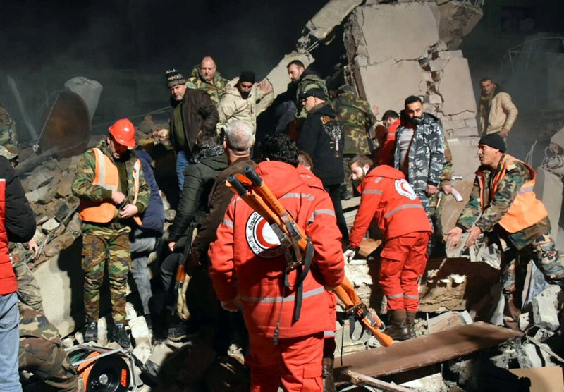 SYRIA-SECURITY/ISRAEL Rescuers search for survivors under the rubble of a damaged building, after Israeli missiles struck a number of sites in Syria's Homs province, according to state media, Syria February 7, 2024. SANA/Handout via REUTERS ATTENTION EDITORS - THIS IMAGE WAS PROVIDED BY A THIRD PARTY. REUTERS IS UNABLE TO INDEPENDENTLY VERIFY THIS IMAGE.