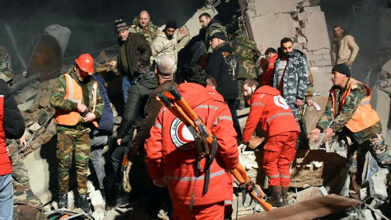 Rescuers search for survivors under the rubble of a damaged building, after Israeli missiles struck a number of sites in Syria's Homs province, according to state media, Syria February 7, 2024. SANA/Handout via REUTERS     ATTENTION EDITORS - THIS IMAGE WAS PROVIDED BY A THIRD PARTY. REUTERS IS UNABLE TO INDEPENDENTLY VERIFY THIS IMAGE.