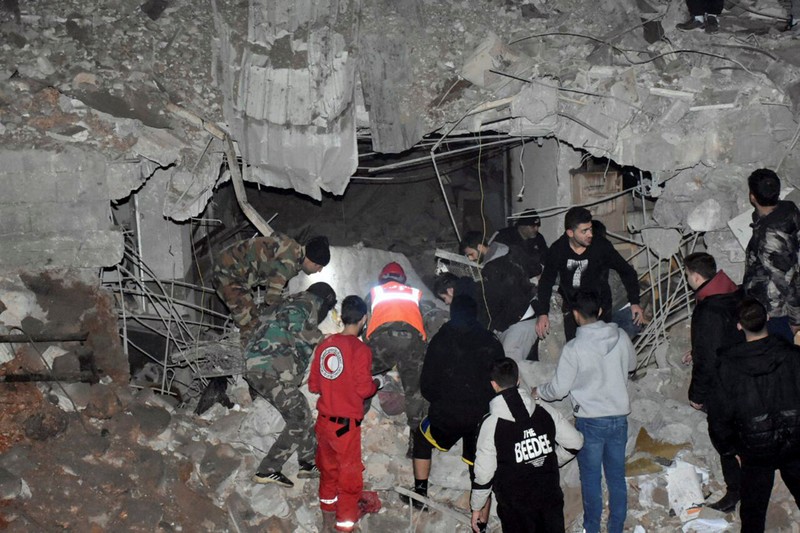 SYRIA-SECURITY/ISRAEL Rescuers search for survivors under the rubble of a damaged building, after Israeli missiles struck a number of sites in Syria's Homs province, according to state media, Syria February 7, 2024. SANA/Handout via REUTERS ATTENTION EDITORS - THIS IMAGE WAS PROVIDED BY A THIRD PARTY. REUTERS IS UNABLE TO INDEPENDENTLY VERIFY THIS IMAGE.
