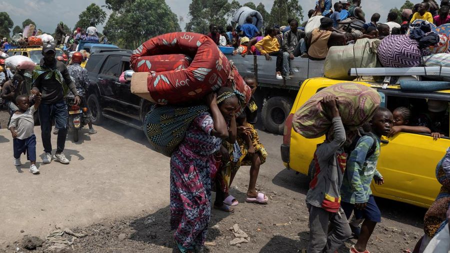 Warga membawa barang-barang saat mengunungsi menuju kota Goma di Republik Demokratik Kongo, Rabu (7/2/2024). (REUTERS/Arlette Bashizi)