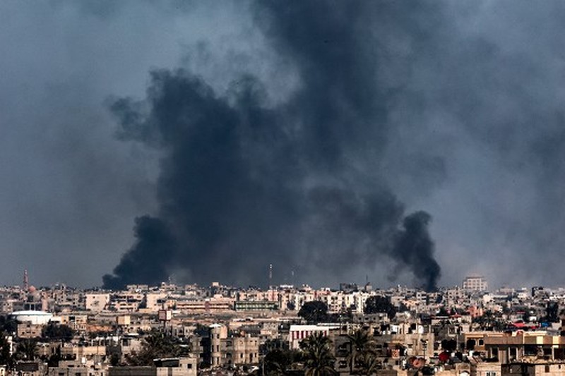 People inspect debris and rubble in a building heavily damaged by Israeli bombardment, in Rafah in the southern Gaza Strip on February 11, 2024, amid the ongoing conflict between Israel and the Palestinian militant group Hamas. (Photo by SAID KHATIB / AFP)