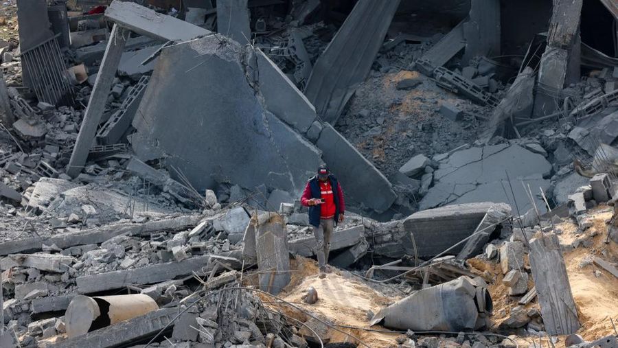 People inspect debris and rubble in a building heavily damaged by Israeli bombardment, in Rafah in the southern Gaza Strip on February 11, 2024, amid the ongoing conflict between Israel and the Palestinian militant group Hamas. (Photo by SAID KHATIB / AFP)