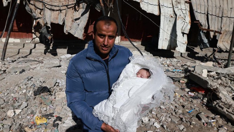 People inspect debris and rubble in a building heavily damaged by Israeli bombardment, in Rafah in the southern Gaza Strip on February 11, 2024, amid the ongoing conflict between Israel and the Palestinian militant group Hamas. (Photo by SAID KHATIB / AFP)