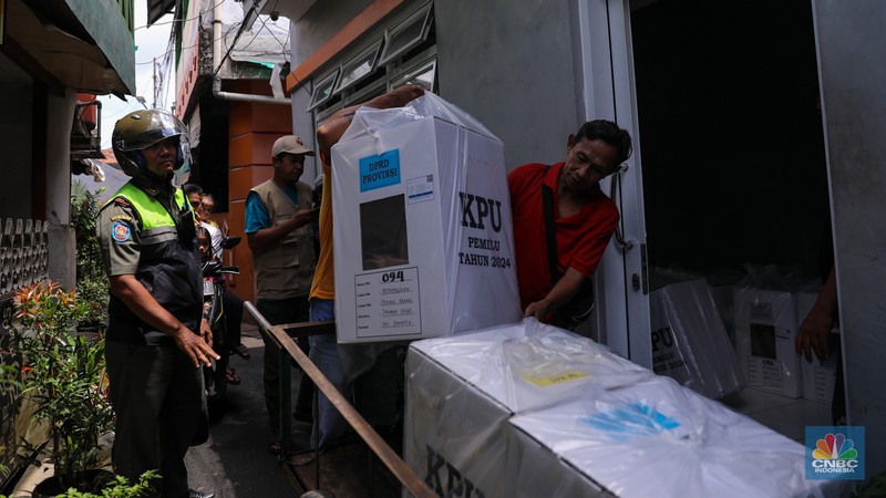 Petugas membawa kotak suara saat pendistribusian logistik Pemilu 2024 pada salah satu pemukiman padat RW 08 di Kelurahan Petamburan, Jakarta, Selasa (13/2/2024). (CNBC Indonesia/Faisal Rahman)