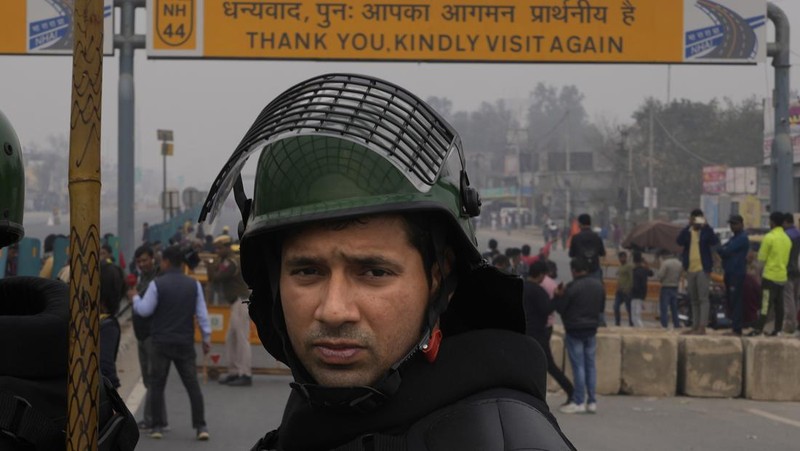 Personel Pasukan Aksi Cepat menjaga jalan raya utama di Singhu dekat New Delhi untuk menghentikan ribuan petani yang melakukan protes memasuki ibu kota, India, Selasa, 13 Februari 2024. Para petani, yang memulai demonstrasi mereka dari negara bagian Haryana utara dan Punjab, meminta agar jaminan harga dukungan minimum untuk semua produk pertanian. (AP Photo/Manish Swarup)