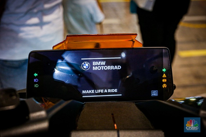Sejumlah pengunjung melihat motor listrik BMW CE-04 di booth BMW Motorrad dalam ajang Indonesia International Motor Show (IIMS 2024) pada Minggu, (17/2/2024). (CNBC Indonesia/Tias Budiarto)