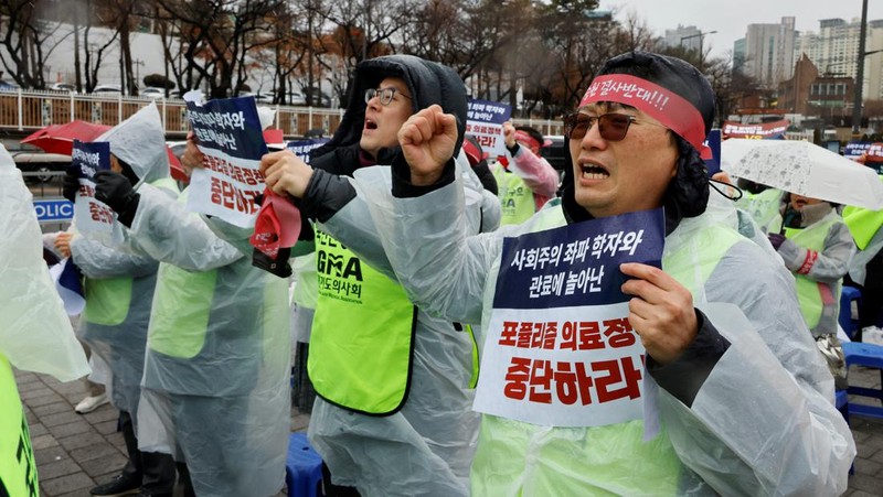 Para dokter dan pekerja medis mengambil bagian dalam protes terhadap rencana penerimaan lebih banyak siswa ke sekolah kedokteran, di depan Kantor Kepresidenan di Seoul, Korea Selatan, 21 Februari 2024. (REUTERS/Kim Soo-Hyeon)
