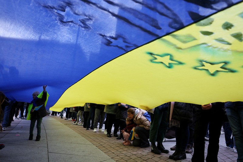 A woman reacts as she visits the grave of her relative, a killed Ukrainian defender, on the day of the second anniversary of Russia's attack on Ukraine, in Lviv, Ukraine February 24, 2024. REUTERS/Pavlo Palamarchuk