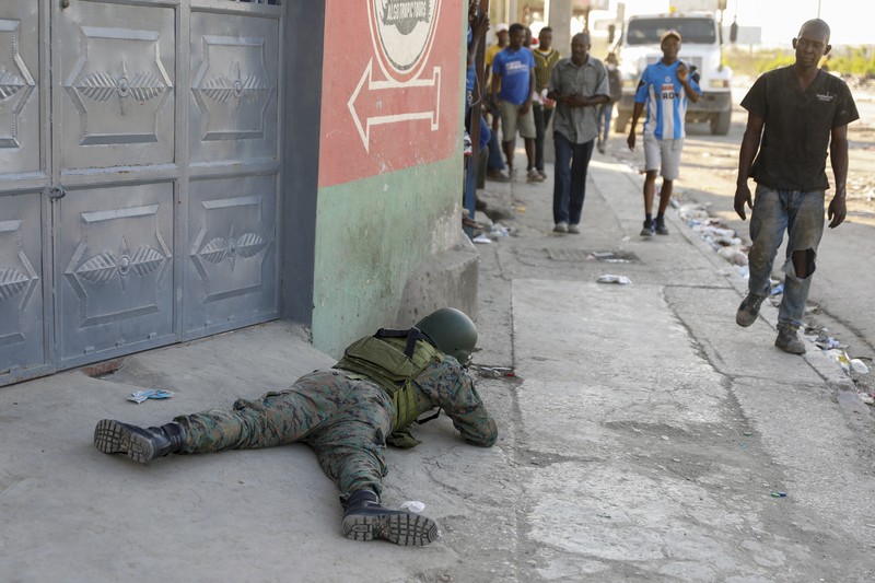 Haiti Violence People stand in a courtyard at the international airport in Port-au-Prince, Haiti, Monday, March 4, 2024. Authorities ordered a 72-hour state of emergency starting Sunday night following violence in which armed gang members overran the two biggest prisons and freed thousands of inmates over the weekend. (AP Photo/Odelyn Joseph)