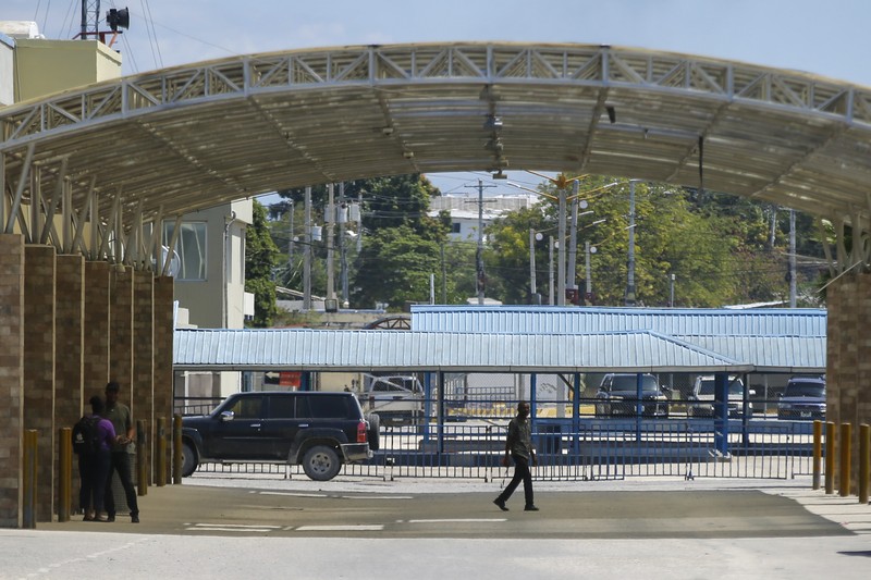 Haiti Violence People stand in a courtyard at the international airport in Port-au-Prince, Haiti, Monday, March 4, 2024. Authorities ordered a 72-hour state of emergency starting Sunday night following violence in which armed gang members overran the two biggest prisons and freed thousands of inmates over the weekend. (AP Photo/Odelyn Joseph)