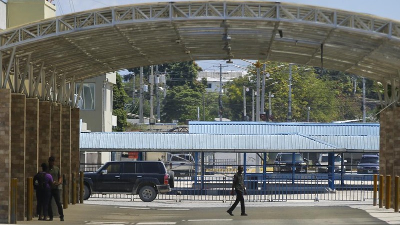 People stand in a courtyard at the international airport in Port-au-Prince, Haiti, Monday, March 4, 2024. Authorities ordered a 72-hour state of emergency starting Sunday night following violence in which armed gang members overran the two biggest prisons and freed thousands of inmates over the weekend. (AP Photo/Odelyn Joseph)