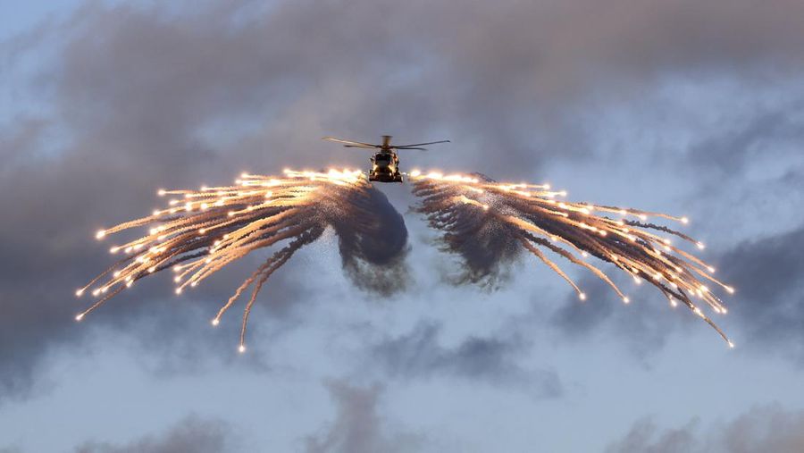 In this image released on Thursday, Feb. 29, 2024, a Merlin helicopter from 820 Naval Air Squadron loaded and fired flares from HMS Prince of Wales, while embarked for NATO Exercise Steadfast Defender. (LPhot Stuart Dickson/British Ministry of Defence via AP)
