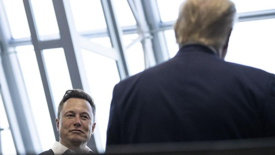 FILE - Tesla and SpaceX Chief Executive Officer Elon Musk talks with President Donald Trump after viewing the SpaceX flight to the International Space Station, at Kennedy Space Center, May 30, 2020, in Cape Canaveral, Fla. Trump and Musk share a reputation as disrupters. Now, they're grappling with tribulations that may be unlike anything thrown at them before. (AP Photo/Alex Brandon, File)