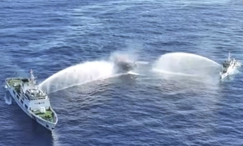 Philippines South China Sea In this image made from video provided by the Philippine Coast Guard, Philippine resupply vessel Unaizah May 4, center, is hit by two Chinese coast guard water canon blasts, causing injuries to multiple crew members as they tried to enter the Second Thomas Shoal, locally known as Ayungin Shoal, in the disputed South China Sea, Tuesday, March 5, 2024. Chinese and Philippine coast guard vessels collided in the disputed South China Sea and multiple Filipino crew members were injured in high-seas confrontations Tuesday as Southeast Asian leaders gathered for a summit that was expected to touch on Beijing's aggression at sea. (Philippine Coast Guard via AP)