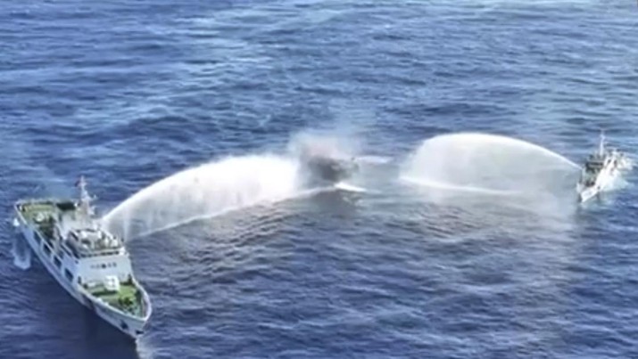 In this image made from video provided by the Philippine Coast Guard, Philippine resupply vessel Unaizah May 4, center, is hit by two Chinese coast guard water canon blasts, causing injuries to multiple crew members as they tried to enter the Second Thomas Shoal, locally known as Ayungin Shoal, in the disputed South China Sea, Tuesday, March 5, 2024. Chinese and Philippine coast guard vessels collided in the disputed South China Sea and multiple Filipino crew members were injured in high-seas confrontations Tuesday as Southeast Asian leaders gathered for a summit that was expected to touch on Beijing's aggression at sea. (Philippine Coast Guard via AP)