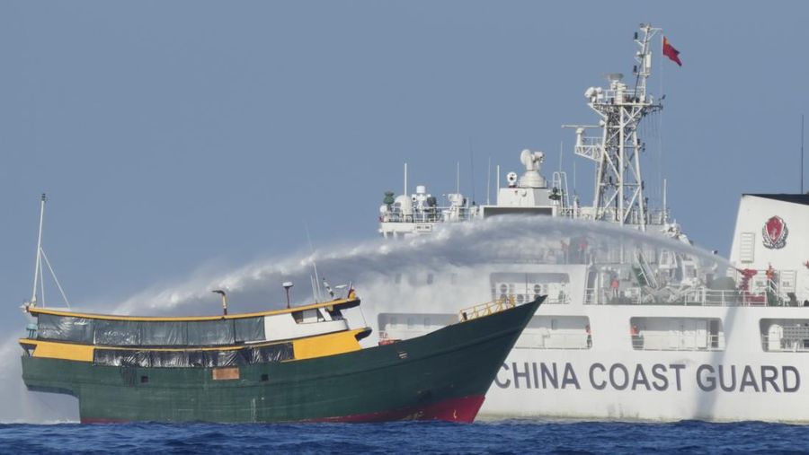 In this image made from video provided by the Philippine Coast Guard, Philippine resupply vessel Unaizah May 4, center, is hit by two Chinese coast guard water canon blasts, causing injuries to multiple crew members as they tried to enter the Second Thomas Shoal, locally known as Ayungin Shoal, in the disputed South China Sea, Tuesday, March 5, 2024. Chinese and Philippine coast guard vessels collided in the disputed South China Sea and multiple Filipino crew members were injured in high-seas confrontations Tuesday as Southeast Asian leaders gathered for a summit that was expected to touch on Beijing's aggression at sea. (Philippine Coast Guard via AP)