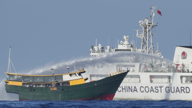 In this image made from video provided by the Philippine Coast Guard, Philippine resupply vessel Unaizah May 4, center, is hit by two Chinese coast guard water canon blasts, causing injuries to multiple crew members as they tried to enter the Second Thomas Shoal, locally known as Ayungin Shoal, in the disputed South China Sea, Tuesday, March 5, 2024. Chinese and Philippine coast guard vessels collided in the disputed South China Sea and multiple Filipino crew members were injured in high-seas confrontations Tuesday as Southeast Asian leaders gathered for a summit that was expected to touch on Beijing's aggression at sea. (Philippine Coast Guard via AP)