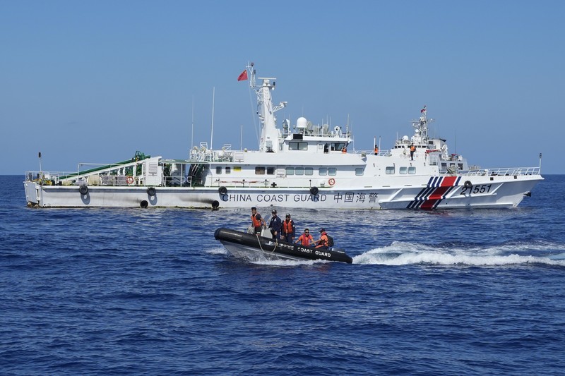 Philippines South China Sea In this image made from video provided by the Philippine Coast Guard, Philippine resupply vessel Unaizah May 4, center, is hit by two Chinese coast guard water canon blasts, causing injuries to multiple crew members as they tried to enter the Second Thomas Shoal, locally known as Ayungin Shoal, in the disputed South China Sea, Tuesday, March 5, 2024. Chinese and Philippine coast guard vessels collided in the disputed South China Sea and multiple Filipino crew members were injured in high-seas confrontations Tuesday as Southeast Asian leaders gathered for a summit that was expected to touch on Beijing's aggression at sea. (Philippine Coast Guard via AP)