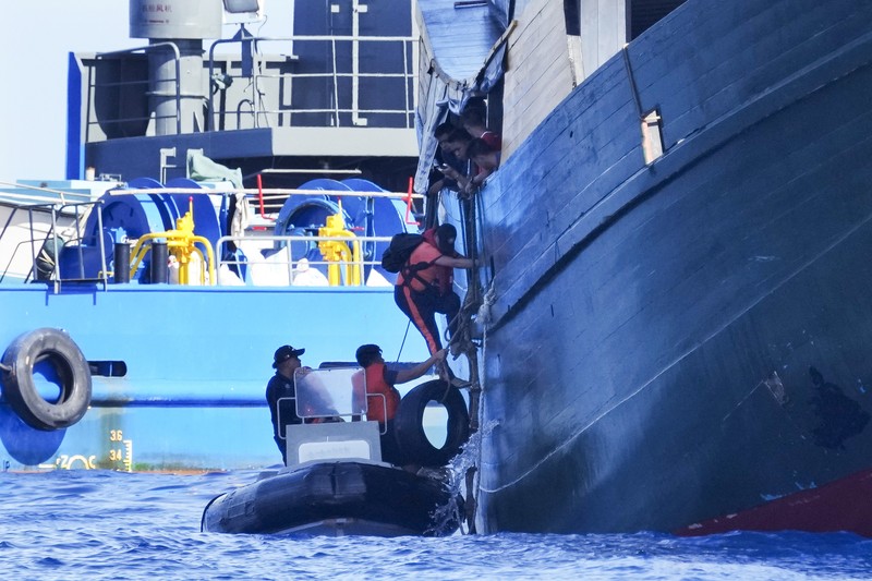 In this image made from video provided by the Philippine Coast Guard, Philippine resupply vessel Unaizah May 4, center, is hit by two Chinese coast guard water canon blasts, causing injuries to multiple crew members as they tried to enter the Second Thomas Shoal, locally known as Ayungin Shoal, in the disputed South China Sea, Tuesday, March 5, 2024. Chinese and Philippine coast guard vessels collided in the disputed South China Sea and multiple Filipino crew members were injured in high-seas confrontations Tuesday as Southeast Asian leaders gathered for a summit that was expected to touch on Beijing's aggression at sea. (Philippine Coast Guard via AP)