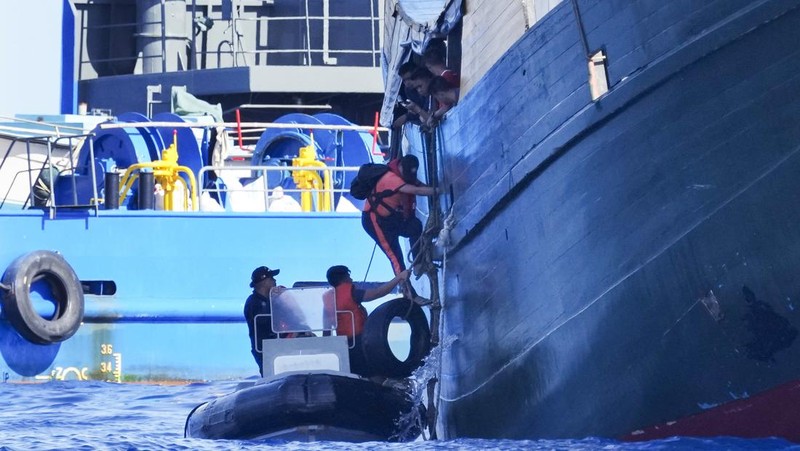 In this image made from video provided by the Philippine Coast Guard, Philippine resupply vessel Unaizah May 4, center, is hit by two Chinese coast guard water canon blasts, causing injuries to multiple crew members as they tried to enter the Second Thomas Shoal, locally known as Ayungin Shoal, in the disputed South China Sea, Tuesday, March 5, 2024. Chinese and Philippine coast guard vessels collided in the disputed South China Sea and multiple Filipino crew members were injured in high-seas confrontations Tuesday as Southeast Asian leaders gathered for a summit that was expected to touch on Beijing's aggression at sea. (Philippine Coast Guard via AP)