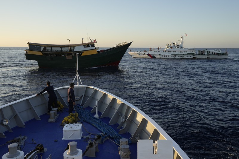 In this image made from video provided by the Philippine Coast Guard, Philippine resupply vessel Unaizah May 4, center, is hit by two Chinese coast guard water canon blasts, causing injuries to multiple crew members as they tried to enter the Second Thomas Shoal, locally known as Ayungin Shoal, in the disputed South China Sea, Tuesday, March 5, 2024. Chinese and Philippine coast guard vessels collided in the disputed South China Sea and multiple Filipino crew members were injured in high-seas confrontations Tuesday as Southeast Asian leaders gathered for a summit that was expected to touch on Beijing's aggression at sea. (Philippine Coast Guard via AP)