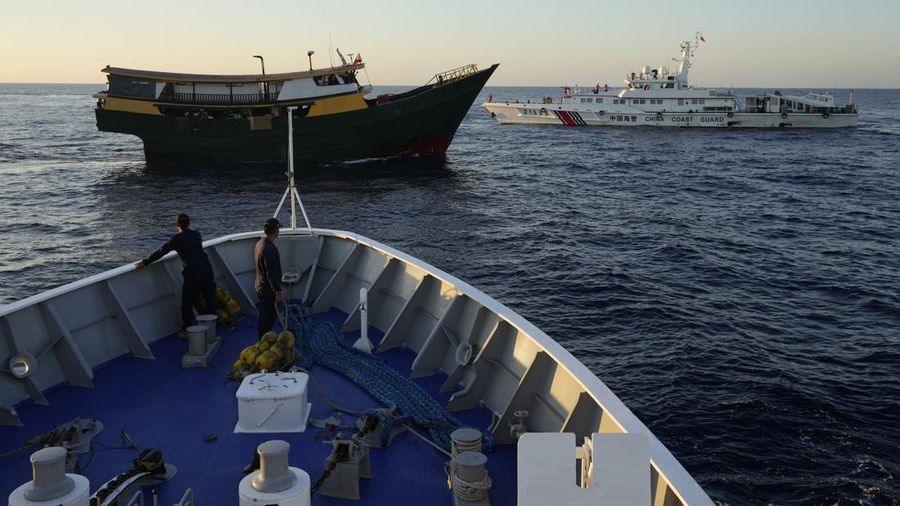 In this image made from video provided by the Philippine Coast Guard, Philippine resupply vessel Unaizah May 4, center, is hit by two Chinese coast guard water canon blasts, causing injuries to multiple crew members as they tried to enter the Second Thomas Shoal, locally known as Ayungin Shoal, in the disputed South China Sea, Tuesday, March 5, 2024. Chinese and Philippine coast guard vessels collided in the disputed South China Sea and multiple Filipino crew members were injured in high-seas confrontations Tuesday as Southeast Asian leaders gathered for a summit that was expected to touch on Beijing's aggression at sea. (Philippine Coast Guard via AP)