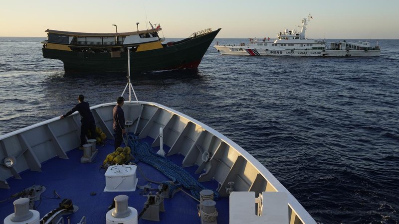In this image made from video provided by the Philippine Coast Guard, Philippine resupply vessel Unaizah May 4, center, is hit by two Chinese coast guard water canon blasts, causing injuries to multiple crew members as they tried to enter the Second Thomas Shoal, locally known as Ayungin Shoal, in the disputed South China Sea, Tuesday, March 5, 2024. Chinese and Philippine coast guard vessels collided in the disputed South China Sea and multiple Filipino crew members were injured in high-seas confrontations Tuesday as Southeast Asian leaders gathered for a summit that was expected to touch on Beijing's aggression at sea. (Philippine Coast Guard via AP)