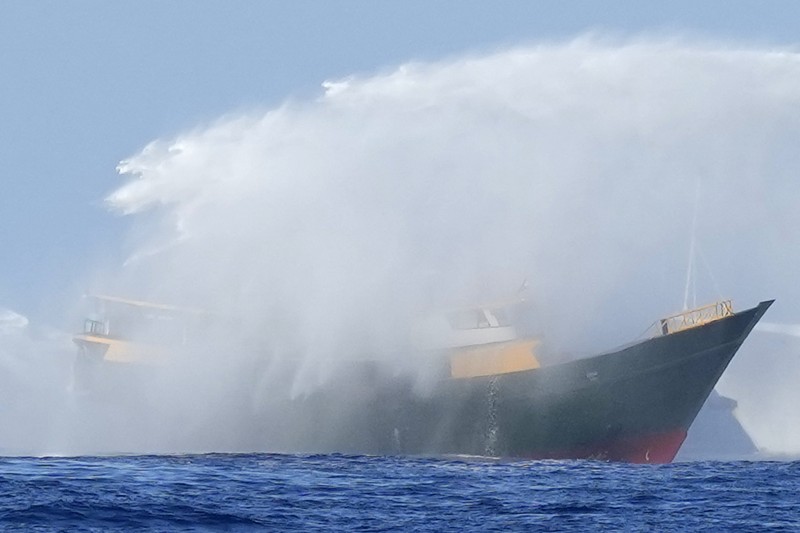 Philippines South China Sea In this image made from video provided by the Philippine Coast Guard, Philippine resupply vessel Unaizah May 4, center, is hit by two Chinese coast guard water canon blasts, causing injuries to multiple crew members as they tried to enter the Second Thomas Shoal, locally known as Ayungin Shoal, in the disputed South China Sea, Tuesday, March 5, 2024. Chinese and Philippine coast guard vessels collided in the disputed South China Sea and multiple Filipino crew members were injured in high-seas confrontations Tuesday as Southeast Asian leaders gathered for a summit that was expected to touch on Beijing's aggression at sea. (Philippine Coast Guard via AP)