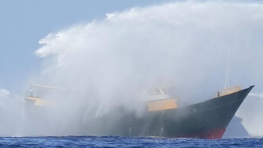 In this image made from video provided by the Philippine Coast Guard, Philippine resupply vessel Unaizah May 4, center, is hit by two Chinese coast guard water canon blasts, causing injuries to multiple crew members as they tried to enter the Second Thomas Shoal, locally known as Ayungin Shoal, in the disputed South China Sea, Tuesday, March 5, 2024. Chinese and Philippine coast guard vessels collided in the disputed South China Sea and multiple Filipino crew members were injured in high-seas confrontations Tuesday as Southeast Asian leaders gathered for a summit that was expected to touch on Beijing's aggression at sea. (Philippine Coast Guard via AP)