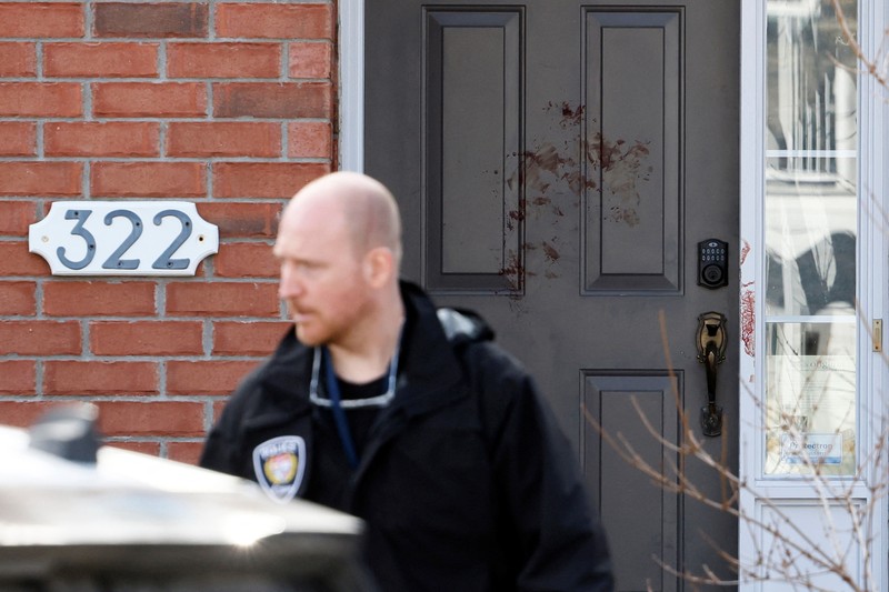 CANADA-OTTAWA/CASUALTIES Ottawa Police Service officers surround a home after four children and two adults were found dead inside a neighbouring house in the Ottawa suburb of Barrhaven, Ontario, Canada March 7, 2024. REUTERS/Blair Gable