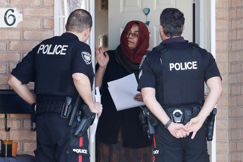 CANADA-OTTAWA/CASUALTIES Ottawa Police Service officers surround a home after four children and two adults were found dead inside a neighbouring house in the Ottawa suburb of Barrhaven, Ontario, Canada March 7, 2024. REUTERS/Blair Gable