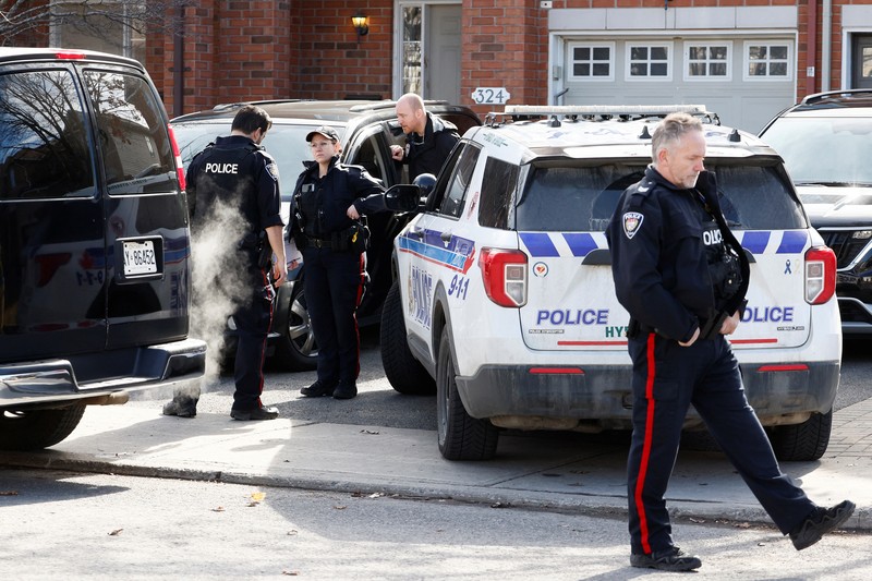 CANADA-OTTAWA/CASUALTIES Ottawa Police Service officers surround a home after four children and two adults were found dead inside a neighbouring house in the Ottawa suburb of Barrhaven, Ontario, Canada March 7, 2024. REUTERS/Blair Gable