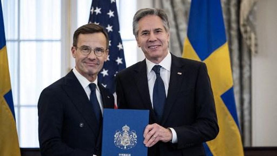 US Secretary of State Antony Blinken receives the NATO ratification documents from Swedish Prime Minister Ulf Kristersson during a ceremony at the US State Department, as Sweden formally joins the North Atlantic alliance, in Washington, DC, on March 7, 2024. Kristersson hailed his country's entry into NATO as a 