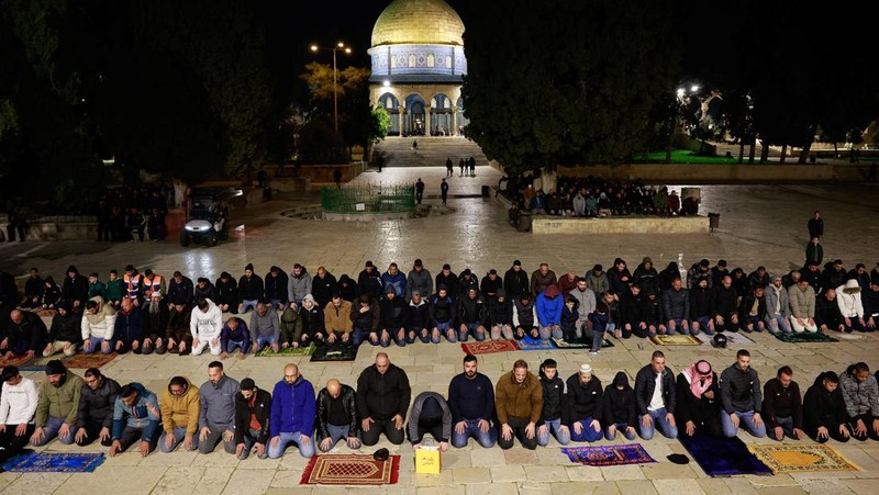 Orang-orang berjalan sebelum mengambil bagian dalam salat malam 'Tarawih' selama bulan suci Ramadhan, di kompleks Al-Aqsa, yang dikenal oleh orang Yahudi sebagai Temple Mount, di Kota Tua Yerusalem 10 Maret 2024. (REUTERS/Ammar Awad)