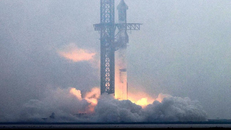 Para pekerja beristirahat sambil memindahkan bebatuan dan puing-puing dari area sekitar saat pesawat luar angkasa Starship generasi berikutnya milik SpaceX yang berada di atas roket Super Heavy. (REUTERS/Cheney Orr)
