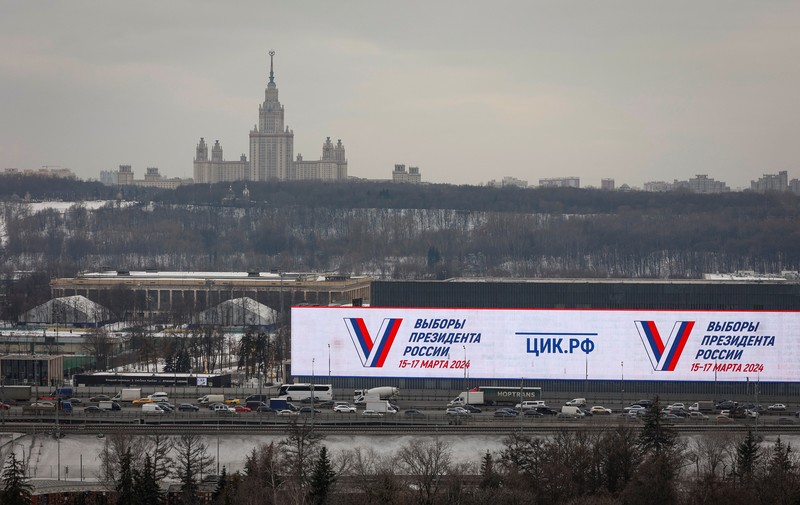 A view shows a screen informing of Russia's presidential election, with the building of Moscow State University (MSU) in the background, in Moscow, Russia March 15, 2024.  REUTERS/Stringer