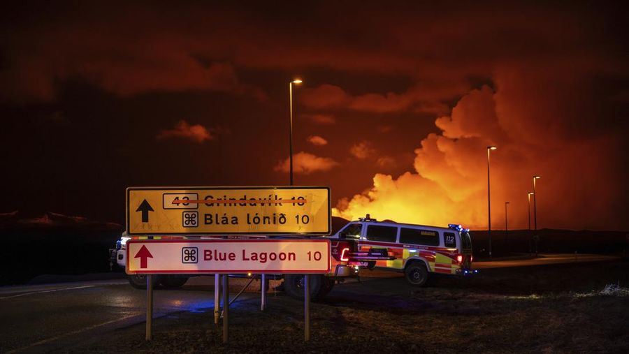Emergency vehicles are stationed on a road leading to volcanic activity between Hagafell and Stóri-Skógfell, Iceland, on Saturday, March 16, 2024. (AP Photo/Marco di Marco)