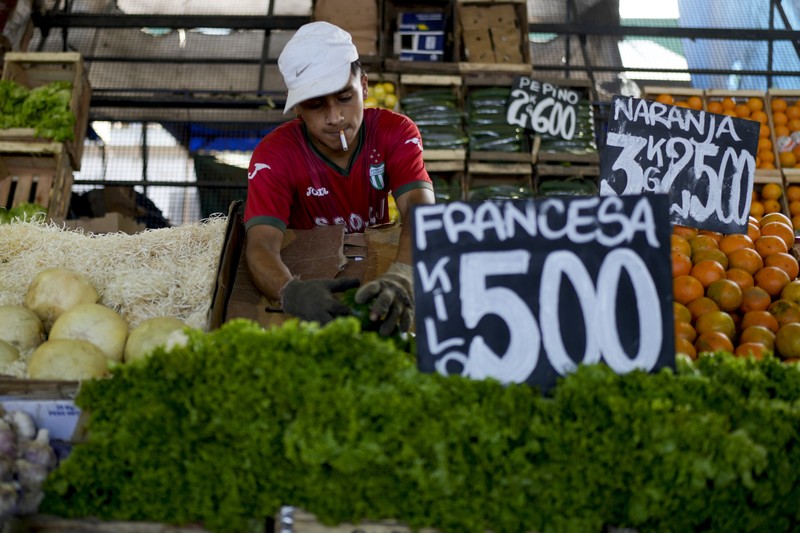 Perempuan mengumpulkan sayuran untuk dibawa pulang setelah dibuang oleh penjual di pasar di pinggiran Buenos Aires, Argentina, Rabu, 10 Januari 2024. (AP Photo/Natacha Pisarenko)