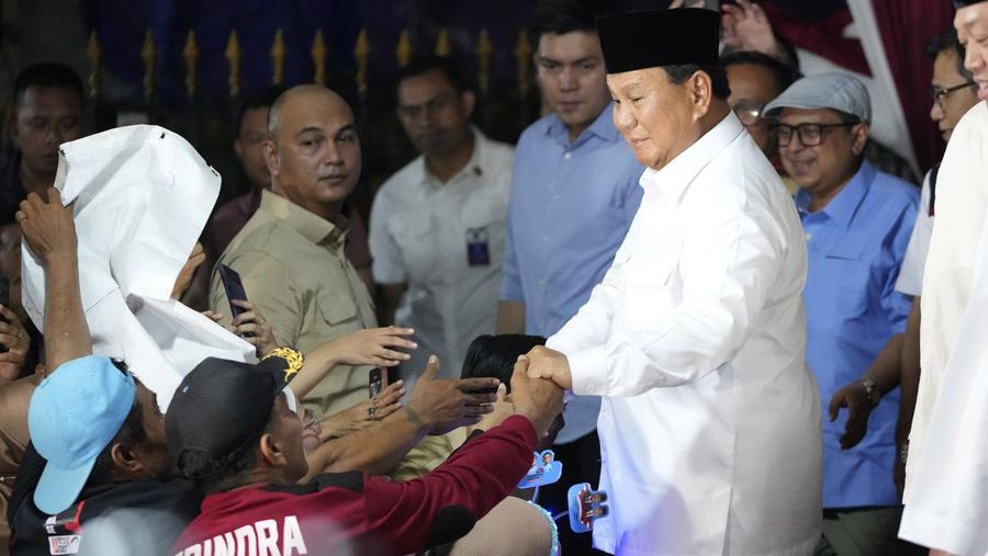 Indonesia's Defense Minister Prabowo Subianto, right, is congratulated by supporters after winning the Feb. 14 election in Jakarta, Indonesia, Wednesday, March 20, 2024. Subianto was announced the winner of last month's presidential election Wednesday over two former governors who have vowed to contest the result in court over alleged irregularities. (AP Photo/Achmad Ibrahim)