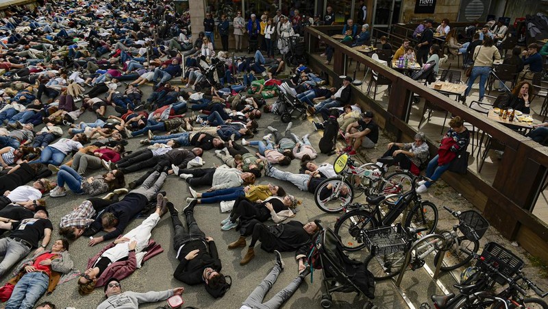 Pro-Palestinian demonstrators lie on the ground as they protest against Israeli attacks on Gaza, in San Sebastian, northern Spain, on Sunday, March 17, 2024. (AP Photo/Alvaro Barrientos)