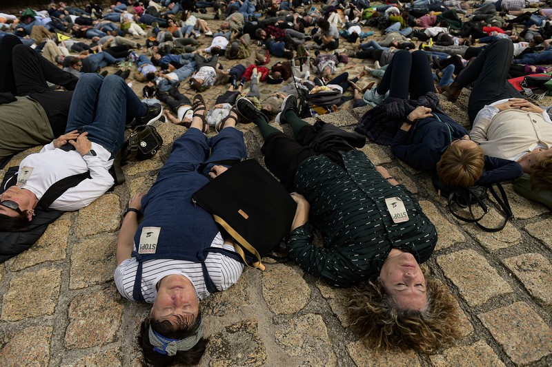 Pro-Palestinian demonstrators lie on the ground as they protest against Israeli attacks on Gaza, in San Sebastian, northern Spain, on Sunday, March 17, 2024. (AP Photo/Alvaro Barrientos)