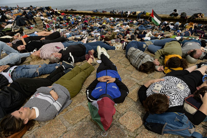 Spain Israel Palestinians Pro-Palestinian demonstrators lie on the ground as they protest against Israeli attacks on Gaza, in San Sebastian, northern Spain, on Sunday, March 17, 2024. (AP Photo/Alvaro Barrientos)