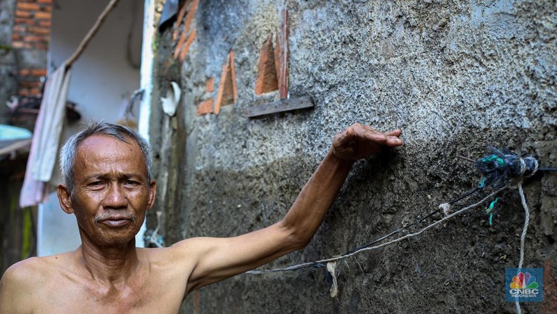 Warga membersihkan rumah usai banjir melanda Kampung Lebak, Kelurahan Teluk Pucung, Kecamatan Bekasi Utara pada Minggu (24/3/2024). (CNBC Indonesia/Tias Budiarto)